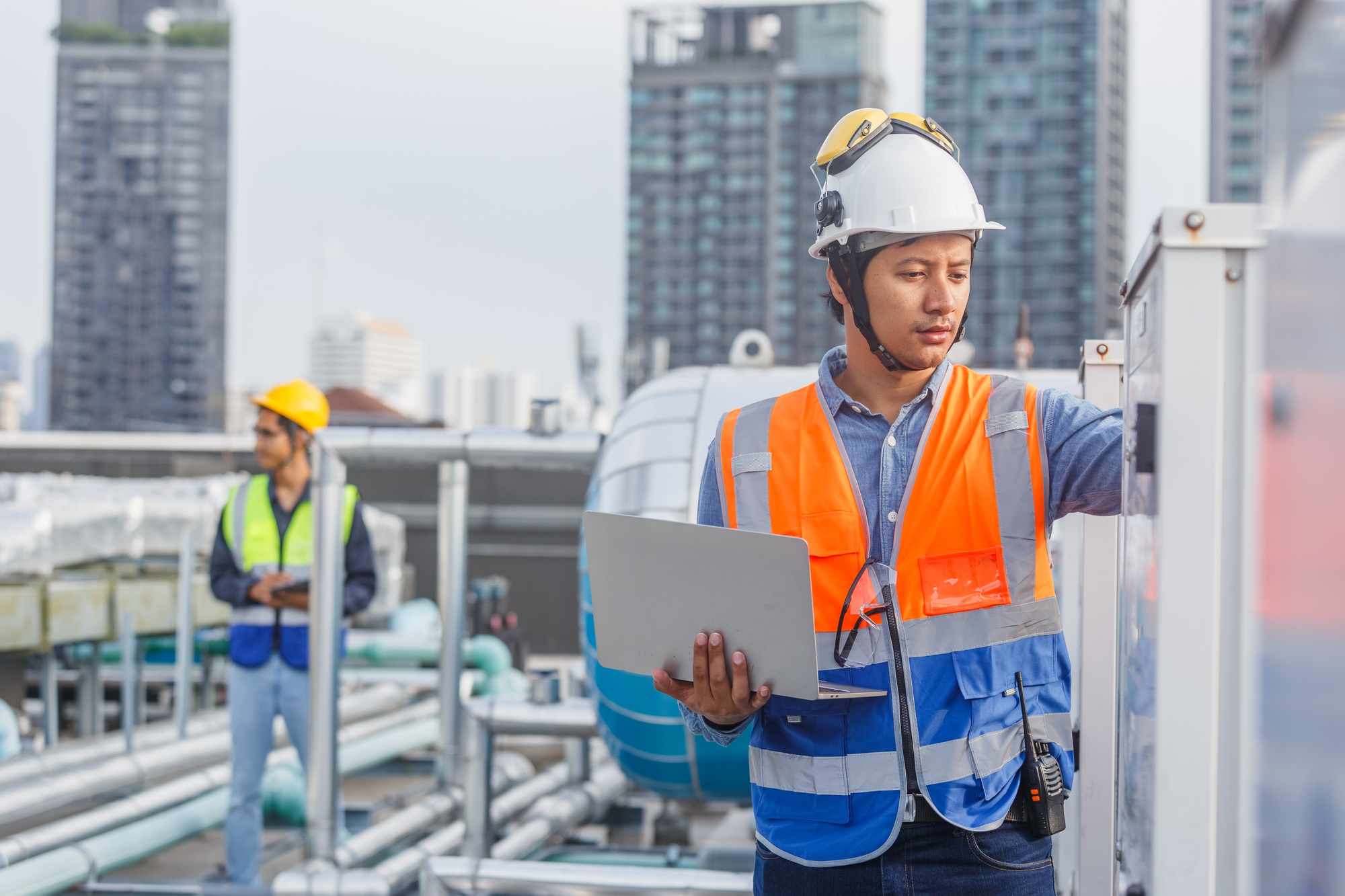 Male technician worker working checking hvac of office building.