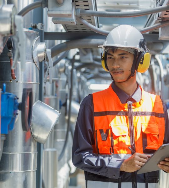 Male operator worker using tablet checking write record quality cooling air piping HVAC